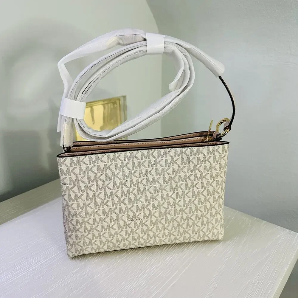 Michael Kors Trisha Medium Logo Crossbody Bag in a vanilla/light cream and pink